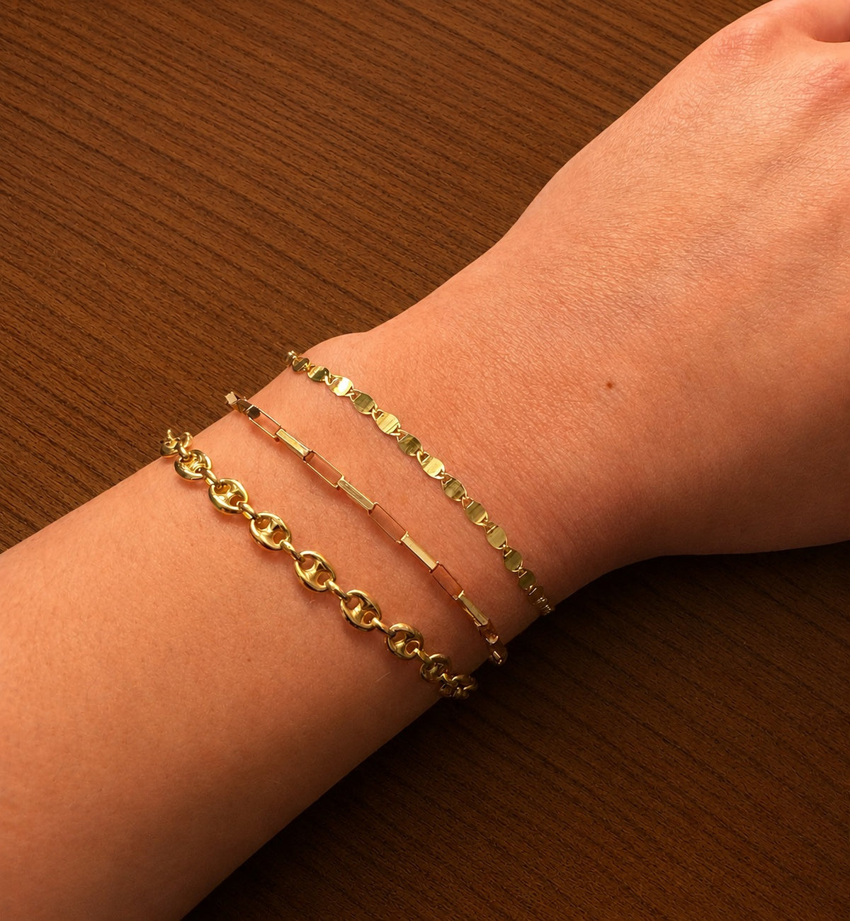 Three bracelets including a 14K Yellow Gold Puff Mariner Link Chain Bracelet and Elongated Box Link Bracelet
