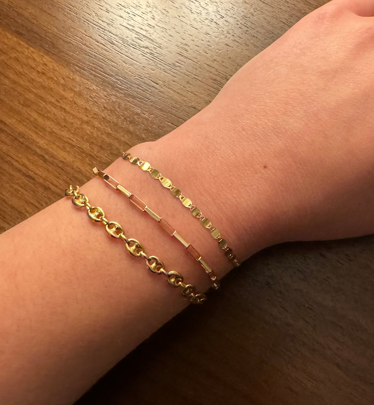 Three bracelets including a 14K Yellow Gold Puff Mariner Link Chain Bracelet and Elongated Box Link Bracelet